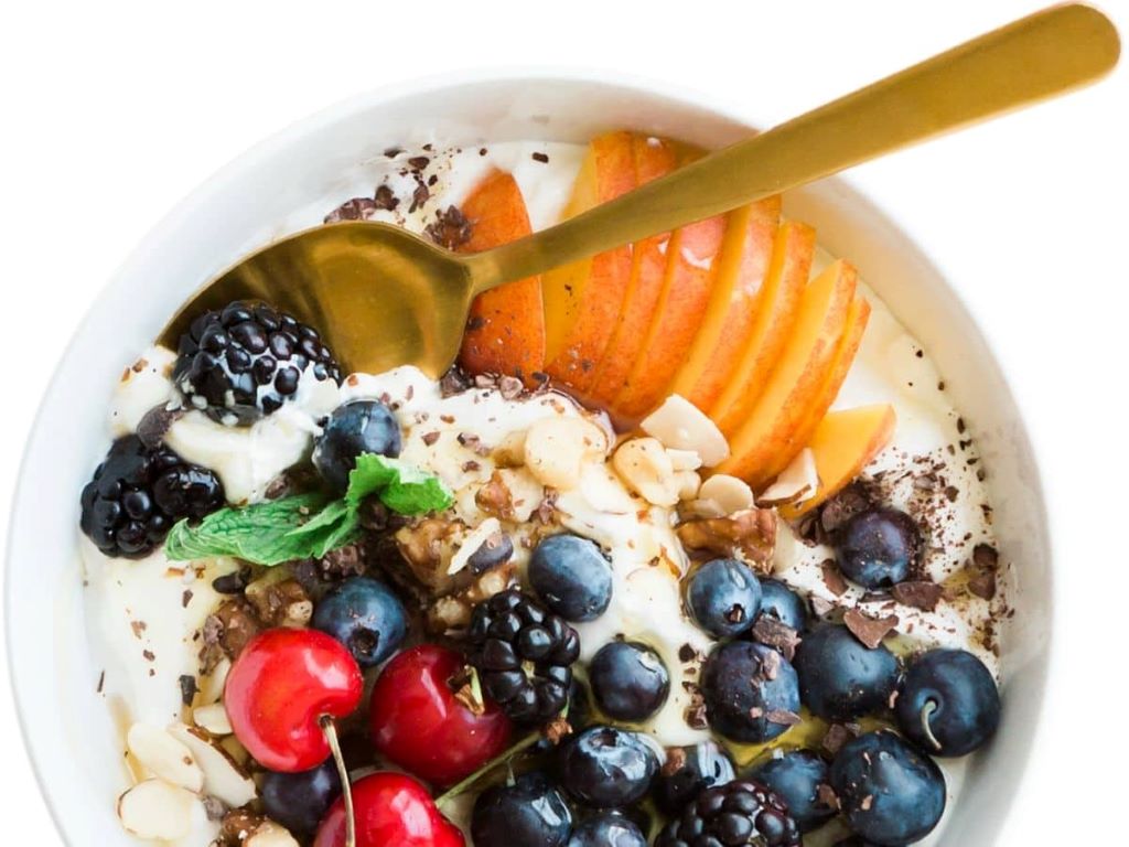 Athlete eating Yoplait yogurt after gym workout for optimal muscle repair