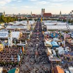 Aerial view of Oktoberfest Munich 2026 festival grounds at Theresienwiese with large beer tents and carnival rides