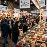 Visitors exploring exhibitor stands at Salon du Chocolat 2026 in Paris, surrounded by artisan chocolate displays