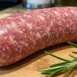 Checking Italian sausage internal temperature with digital thermometer